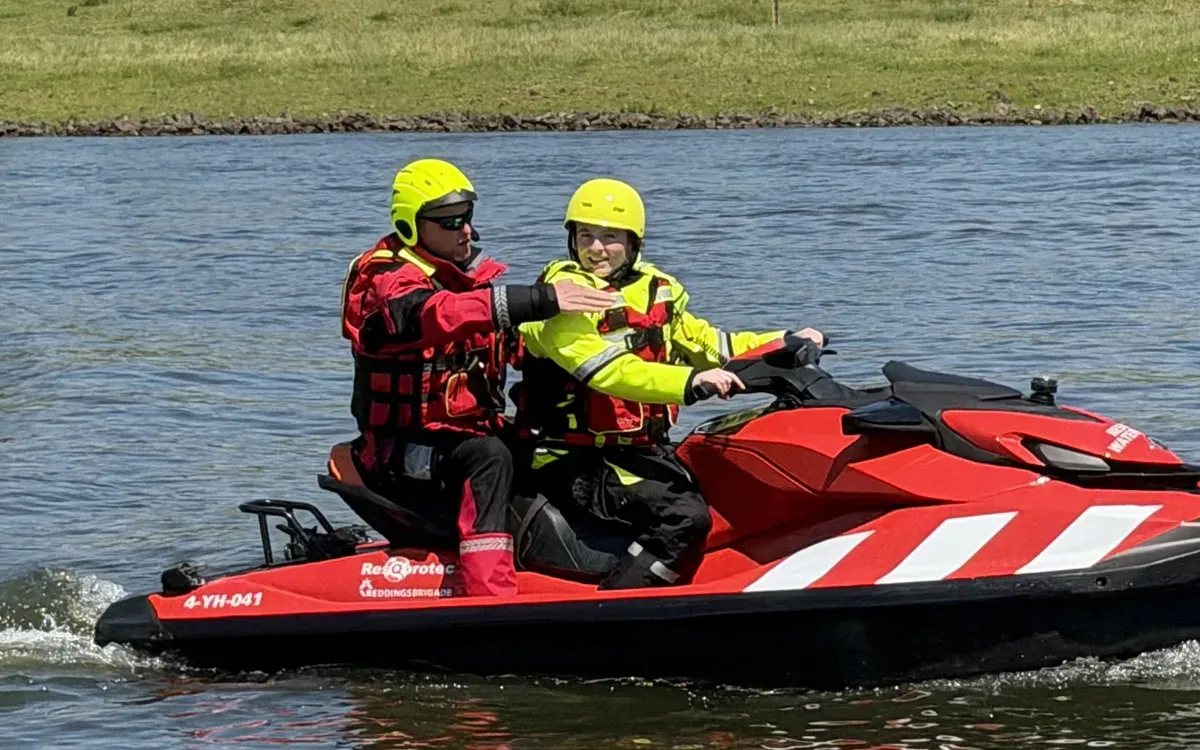 Instructor guiding a participant on a rescue watercraft