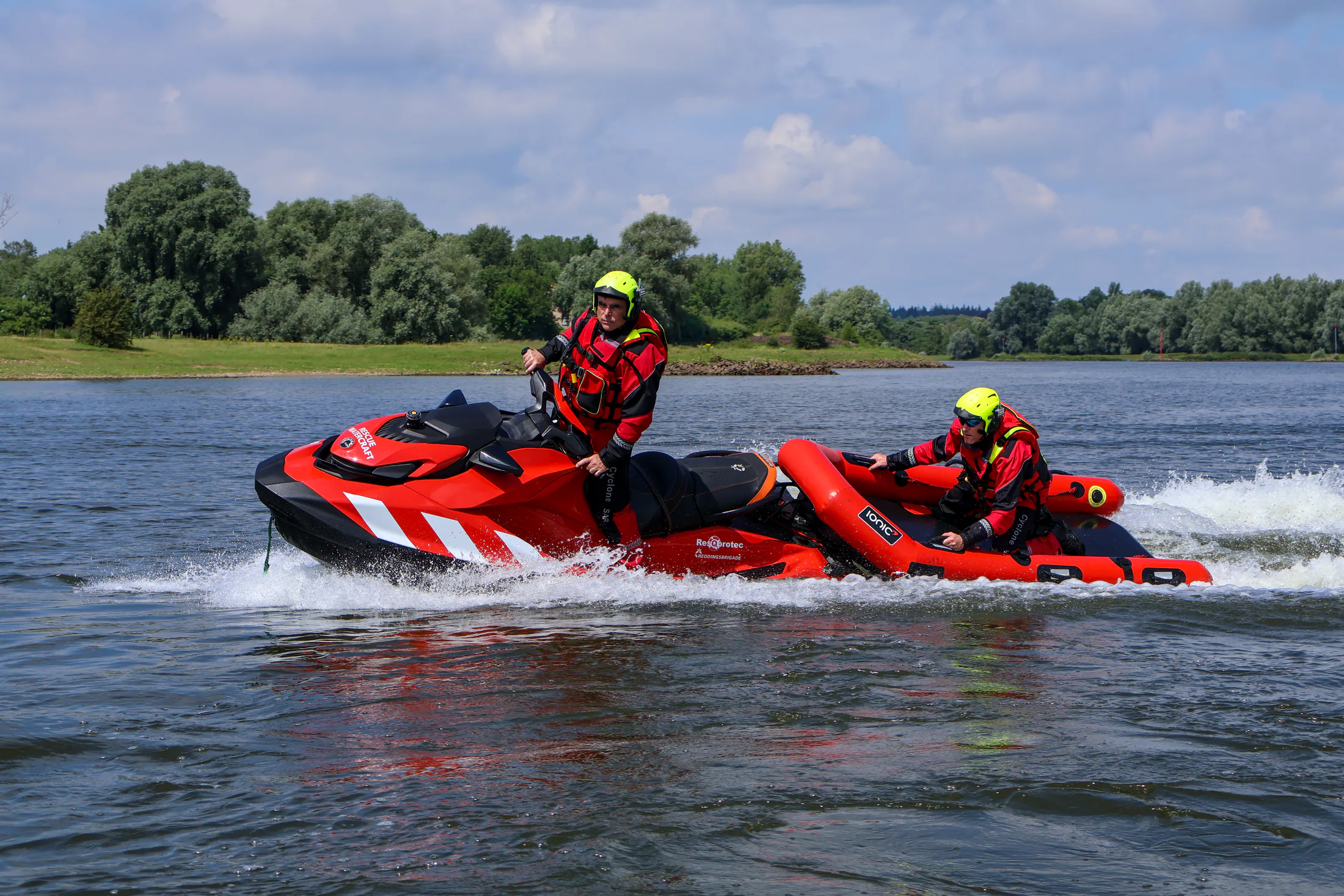Two rescuers on a rescue jet ski with the Rescue Raft sled on the water