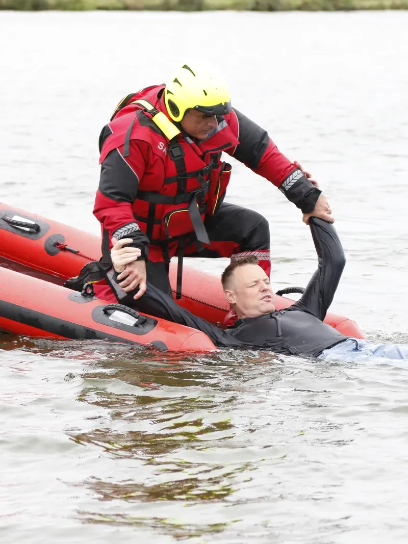 Rescuer recovering a casualty from the water with a rescue sled