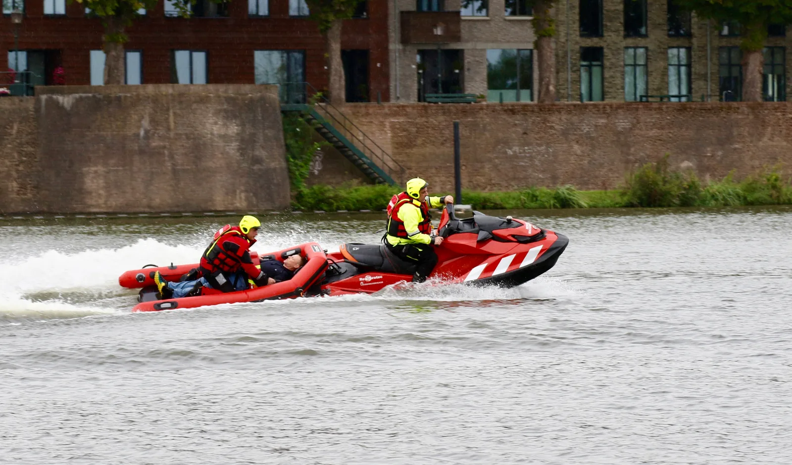 Rescue watercraft and rescue sled transporting a casualty with two rescuers