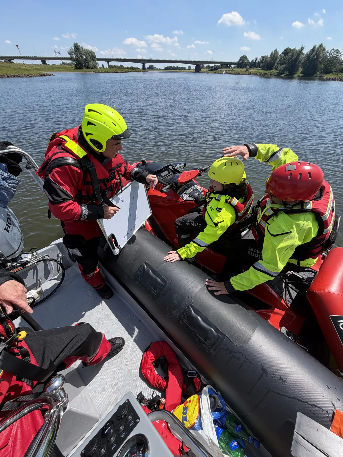 Instructor briefing participants beside a rescue watercraft